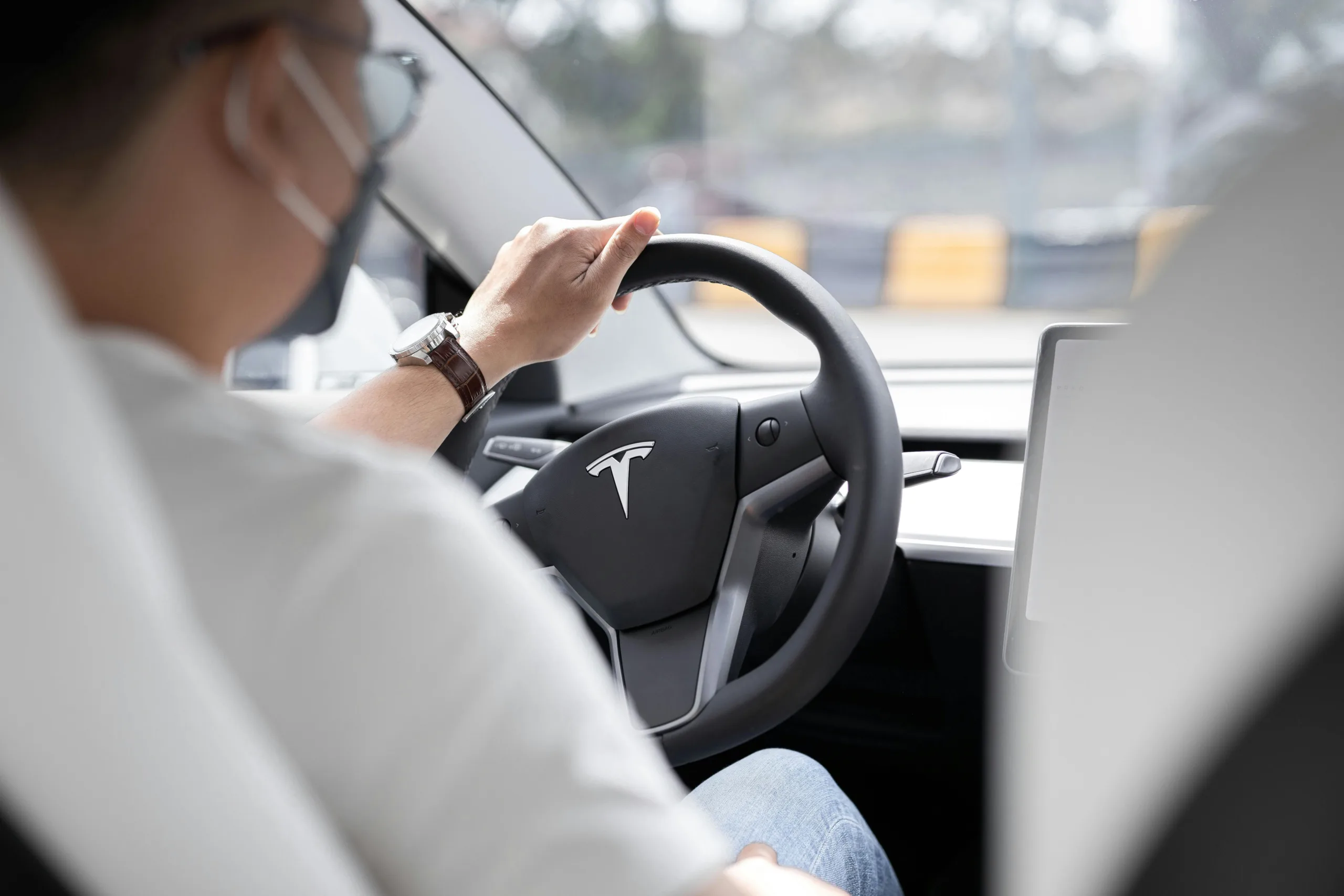 Driver taking control of their car steering wheel