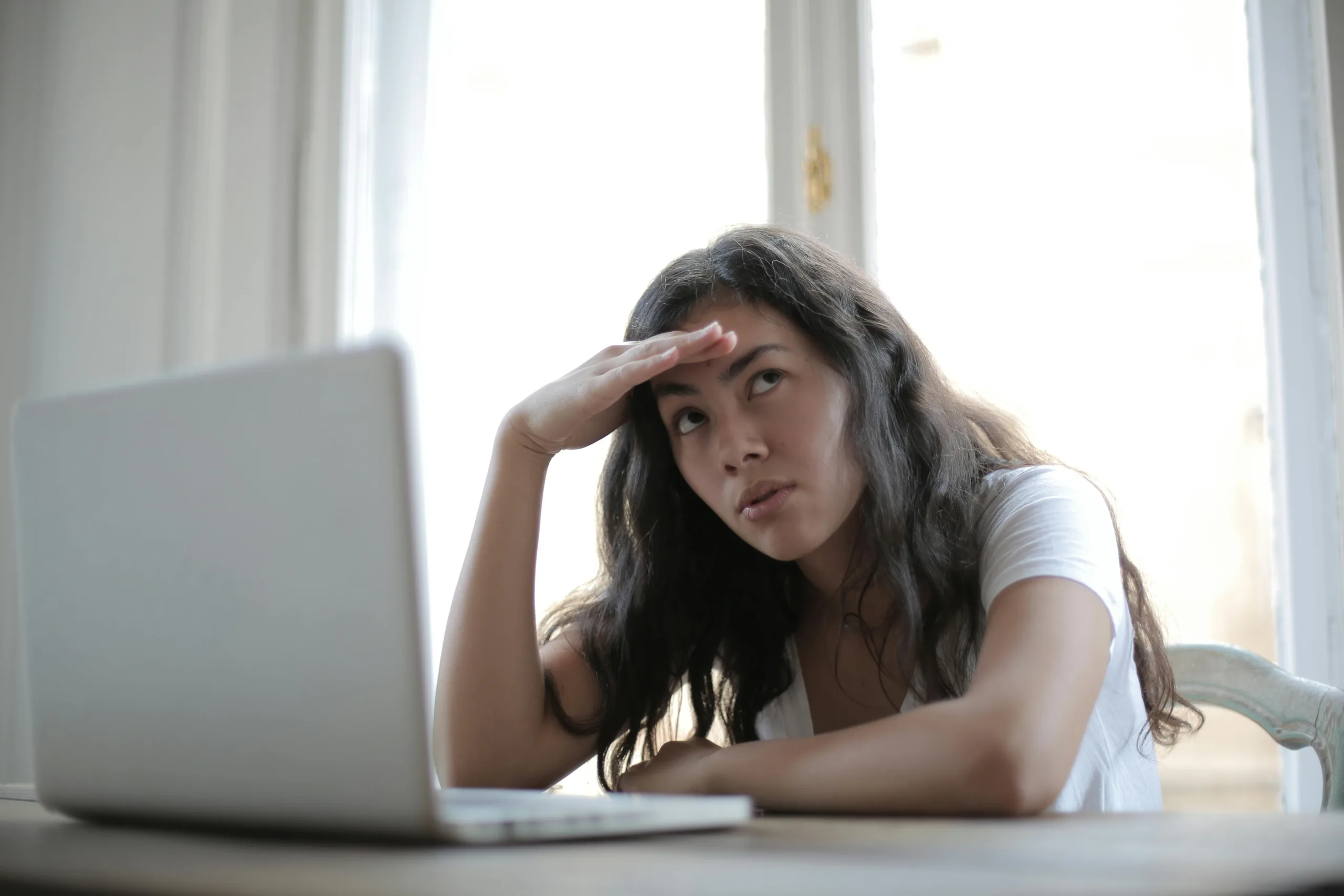 Young female at laptop disappointed.